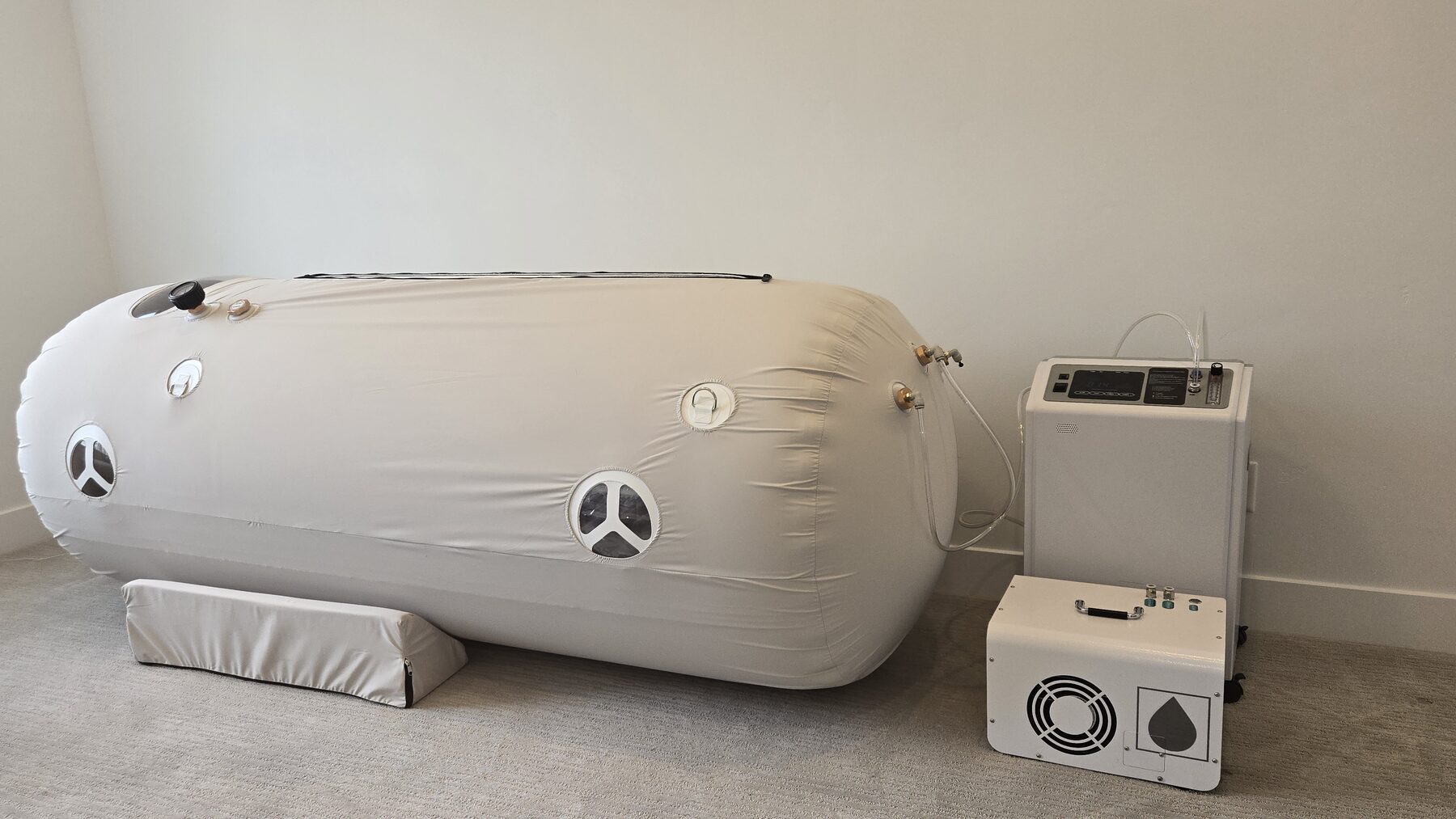 Three-quarter view of the Purebaric soft-shell hyperbaric chamber with viewing ports.