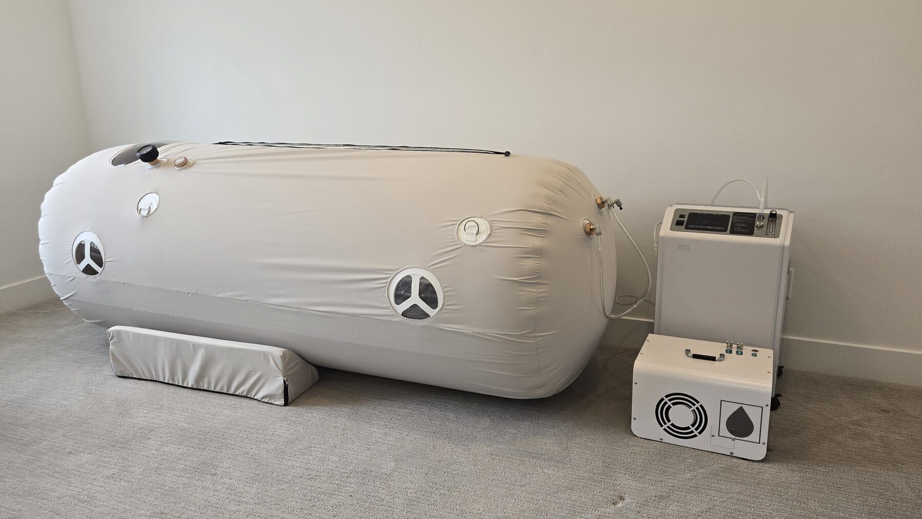 The Purebaric chamber set up in a home with its oxygen concentrator.